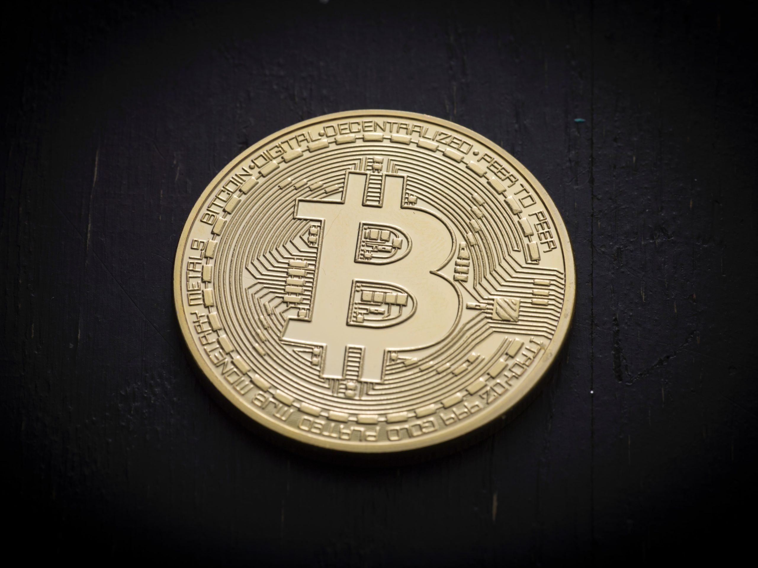 Golden circular token with a B for Bitcoin