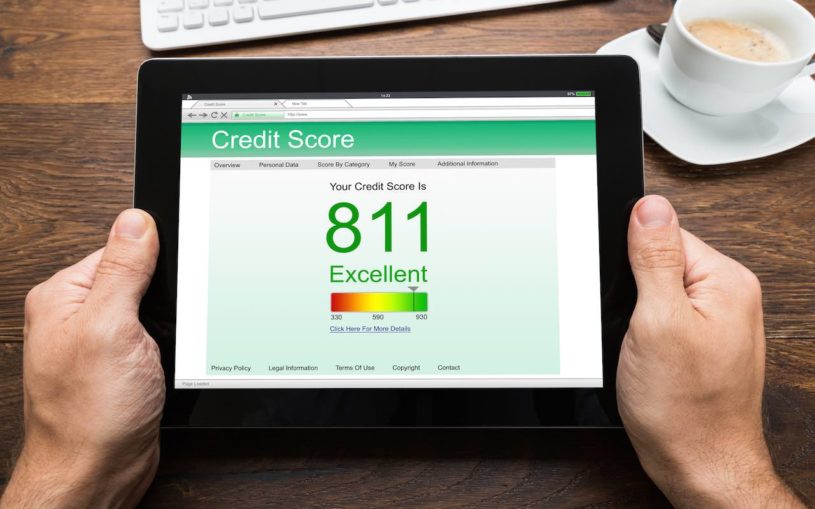 Person holding iPad to check new machine learning calculated credit score