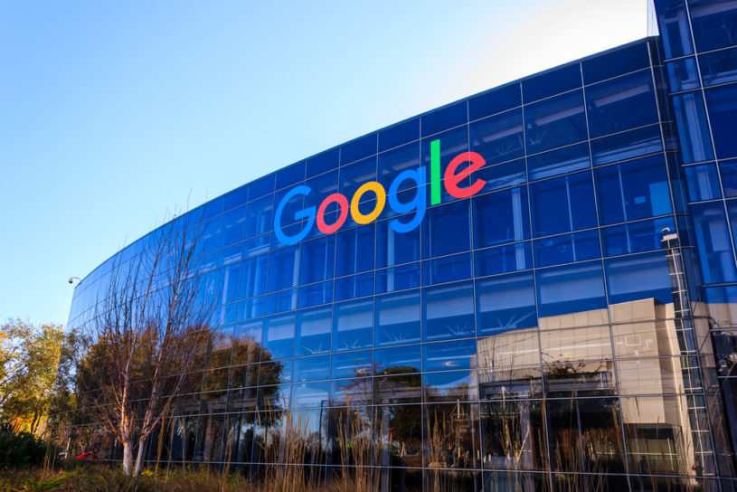Outside view of Google building with colored Google lettering and blue sky in background