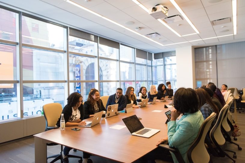 Group of women sitting around a conference table discussing FinTech