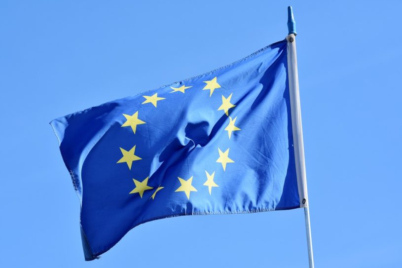 European Union flag waving in wind with blue sky in backgorund