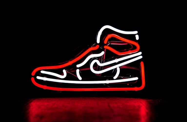 Nike shoe in red and white neon lights