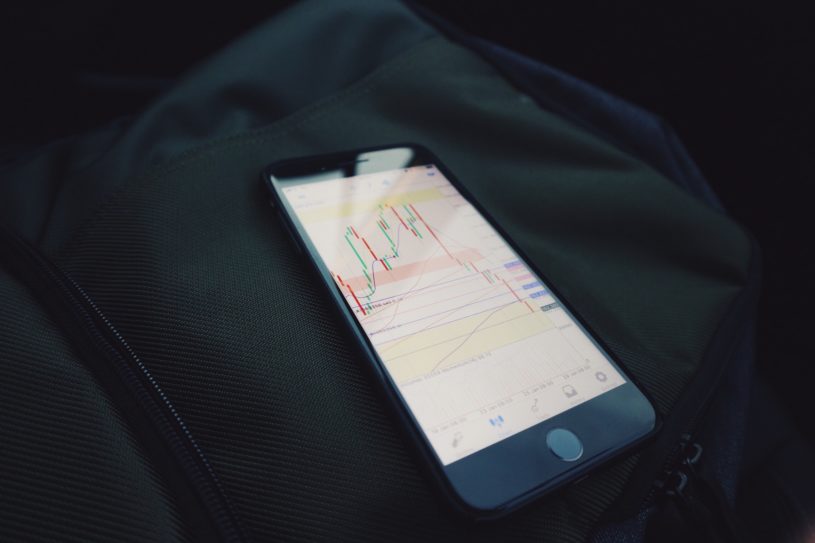 iPhone being used with a stock trading app to buy