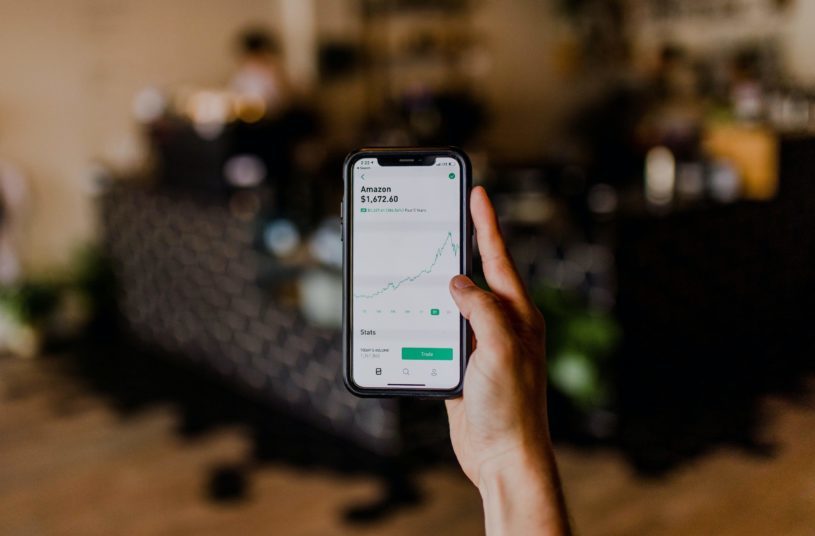 Person using a stock app to buy stocks during second COVID-19 spike