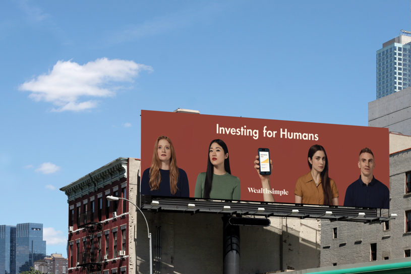 Billboard with millennial investors trading cryptocurrency with Wealthsimple's robo advisor