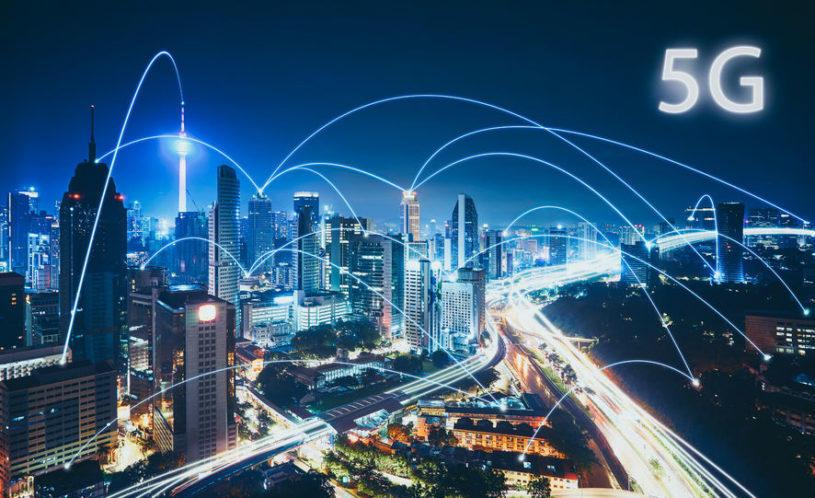 Several skyscraper buildings in a city, all connected by 5G technology.