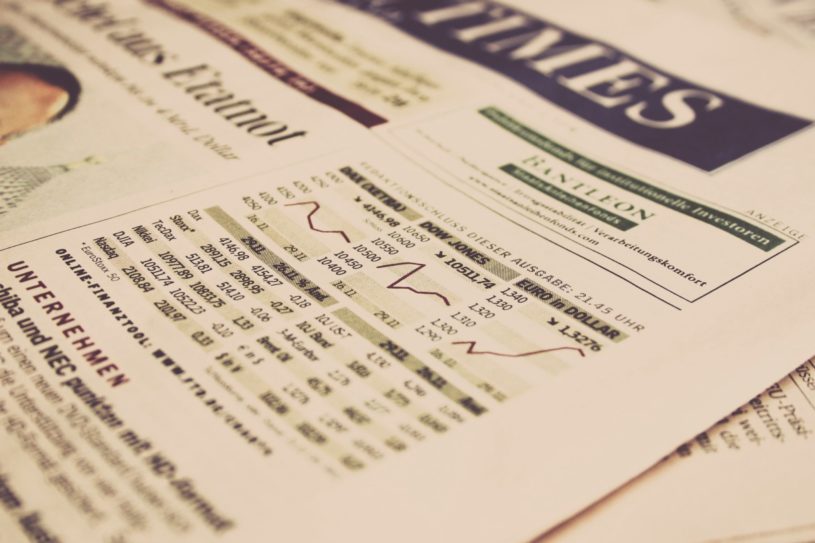 Newspaper showing financial charts that illustrate the impact of institutional investors entering the crypto space.