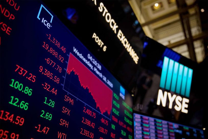 New York Stock Exchange digital sign with financial charts highlighting the top stocks to buy in October 2020