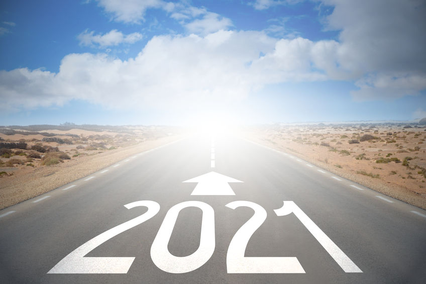 An image of a road leading to brighter days as the world shifts into the year 2021 with "2021" written on the road.