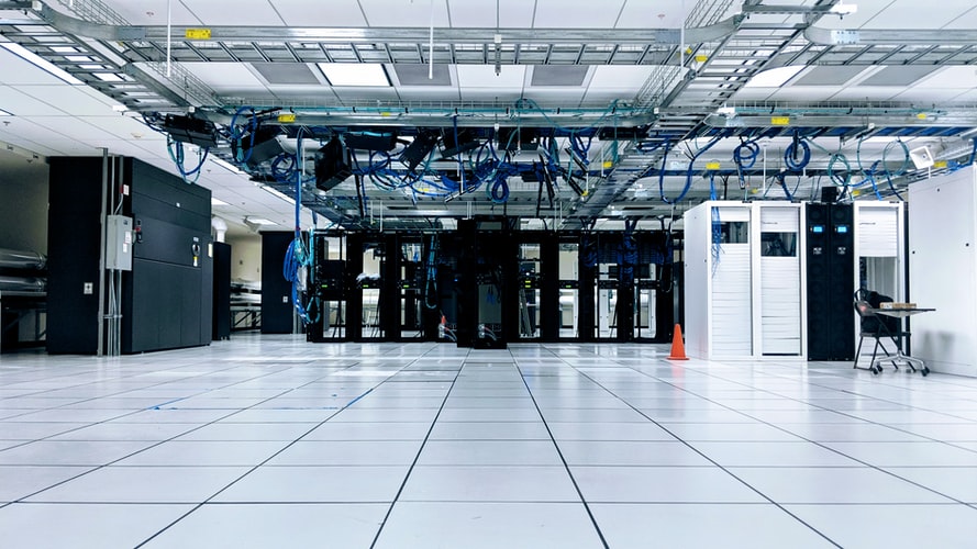 Server racks in a sterile, white, climatized space.