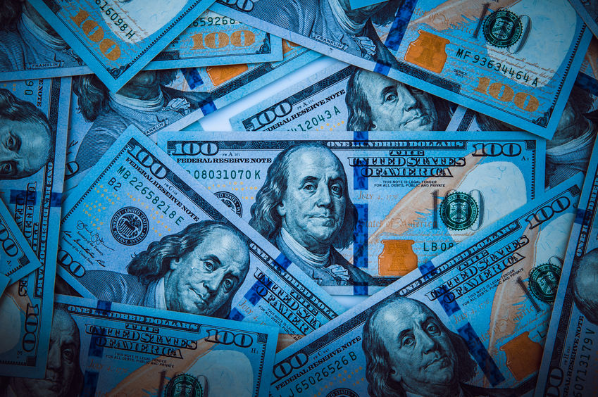 The background of a one hundred dollar bill with a light blue shaded color.