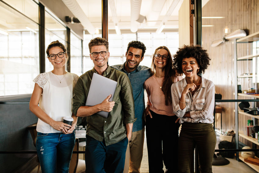 Group of millennials standing together and discussing the growth of Bitcoin