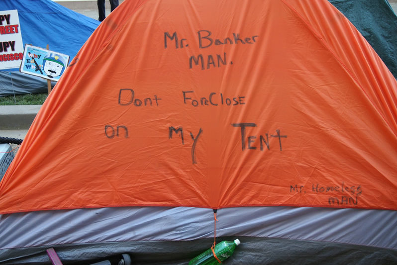 Tent with writing of Mr. Banker Man. Don't Forclose on my tent,