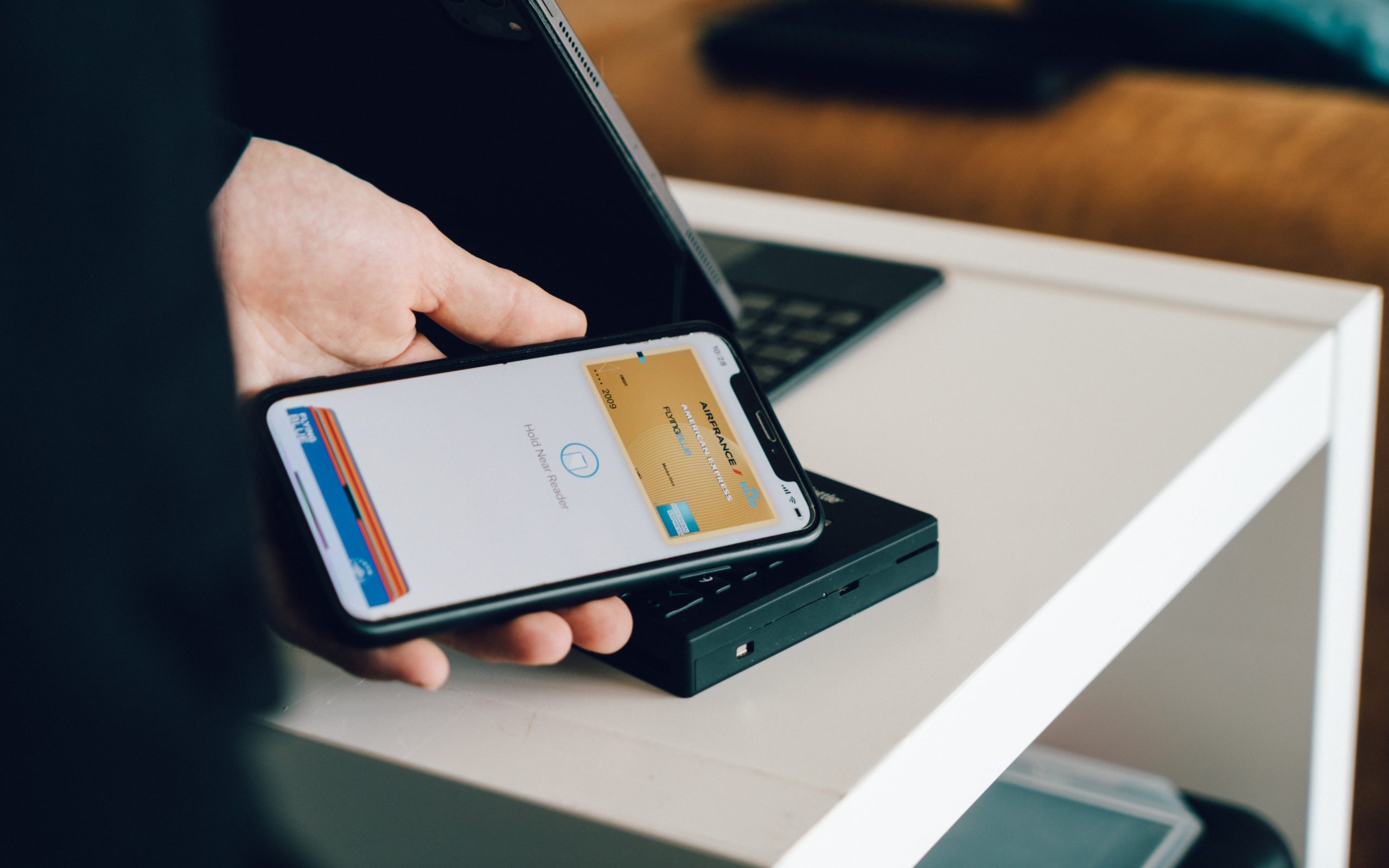 A man holding a smartphone showcasing the digitization of finance
