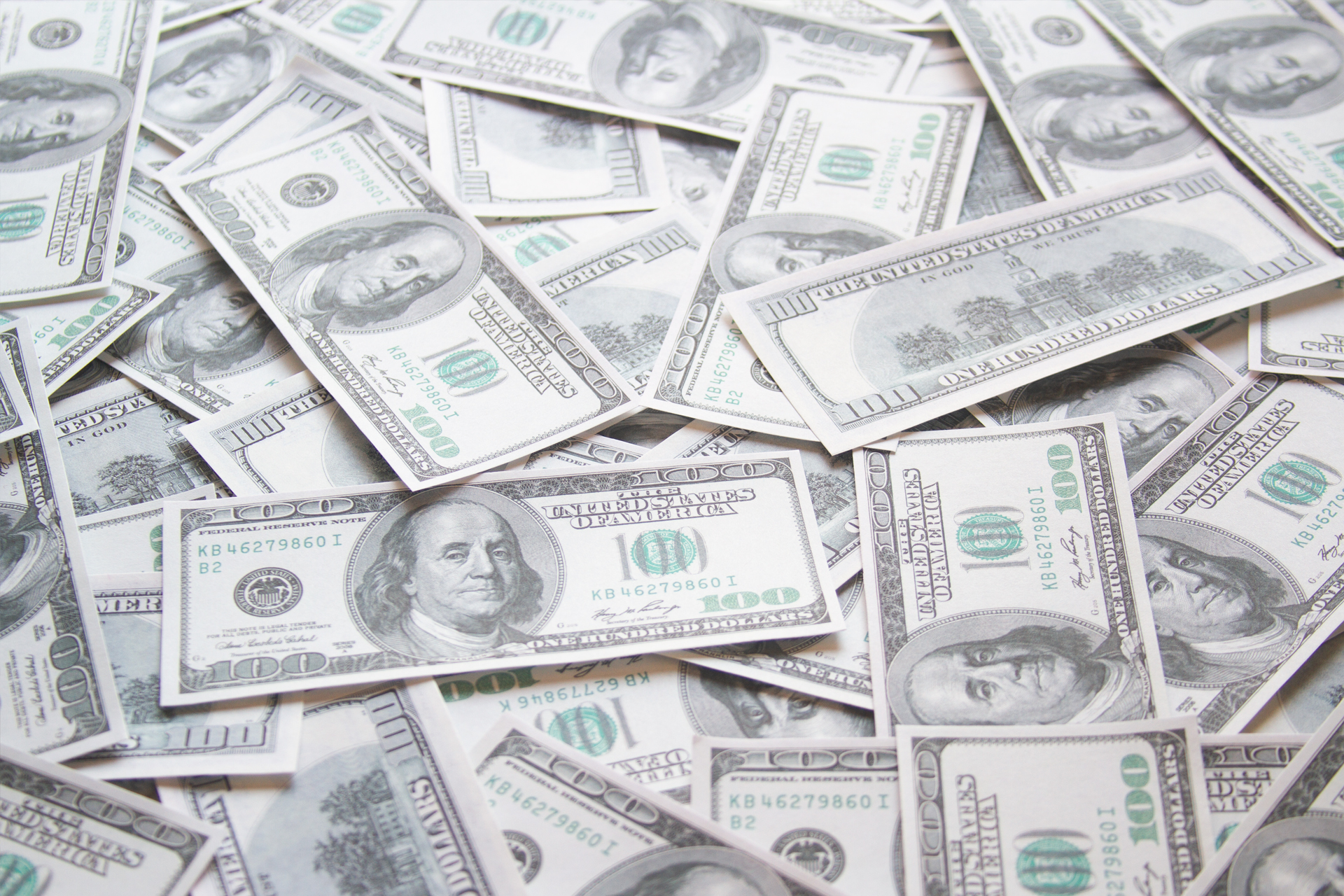 A lot of dollars in $100 bills scattered on ground