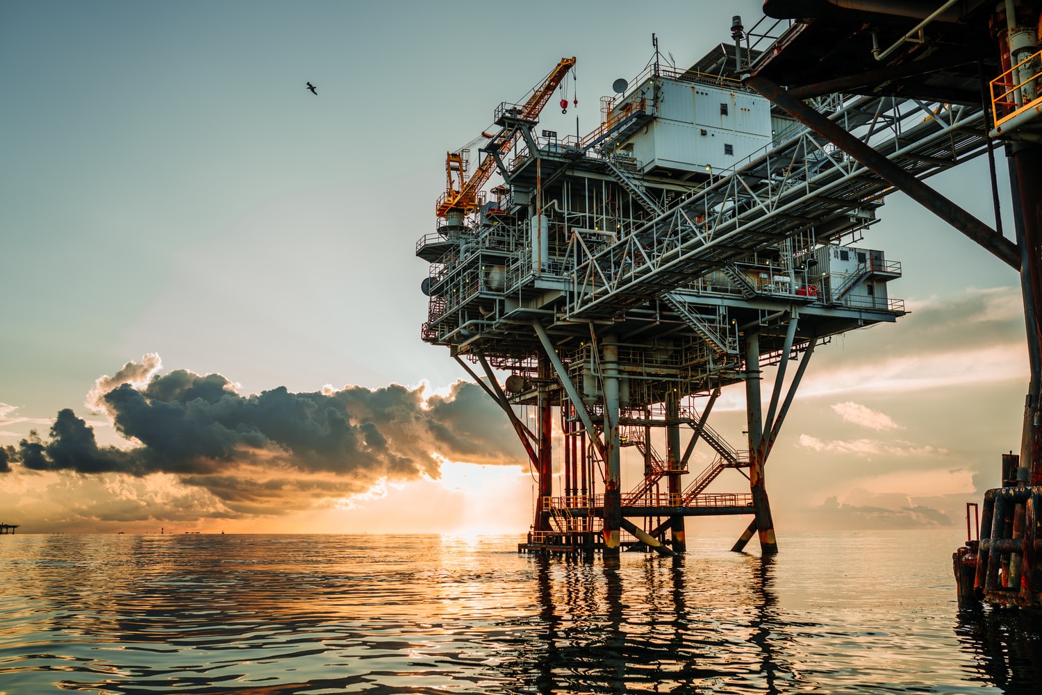 Shallow oil rig during a sunset.