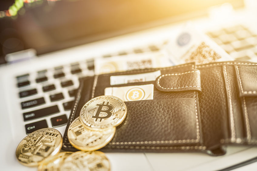 Virtual currency wallet. Bitcoin gold coin and printed encrypted money with QR code. Cryptocurrency concept.