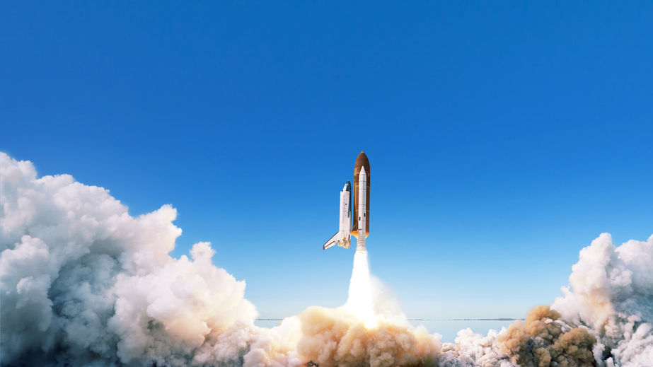 Spacecraft takes off into space. The rocket starts in the blue sky. Travel concept