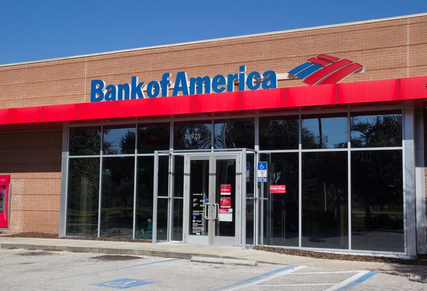 Brick building with glass windows and doors, with "Bank of America" sign in blue lettering.