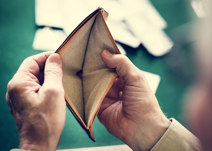 Hands holding empty wallet in a cards circle