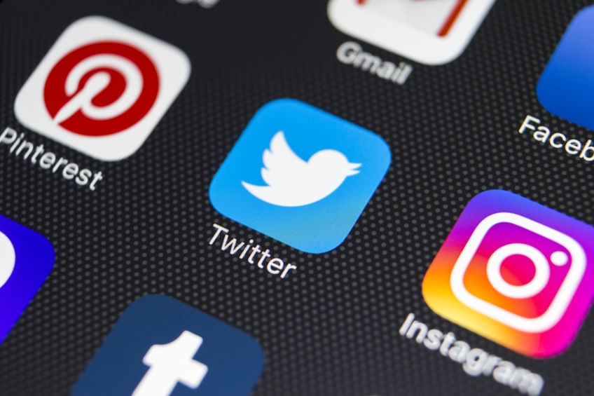 Applications open on a smartphone, including Twitter, Pinterest, and Instagram