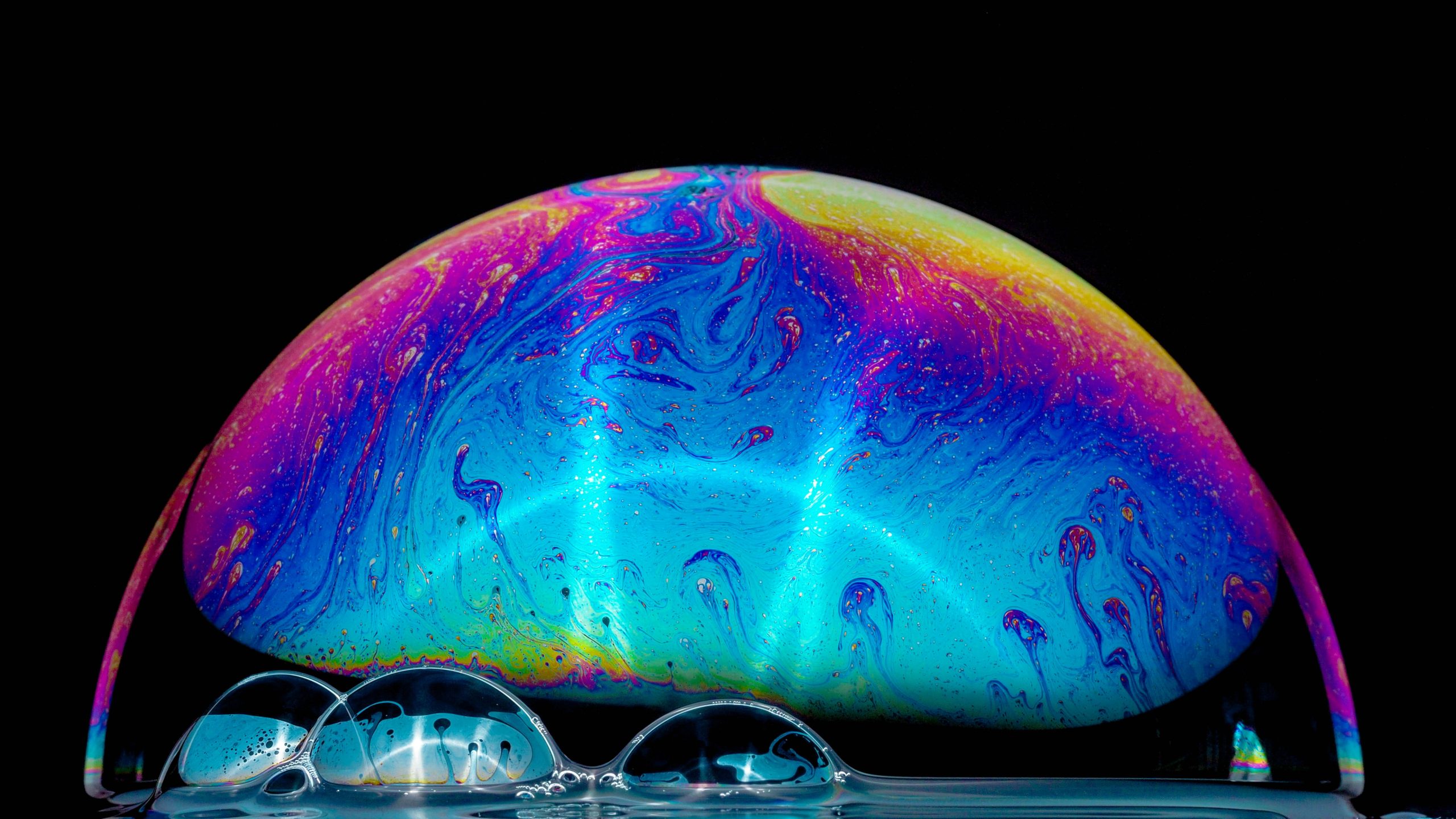 large multi-colored bubble next to smaller ones.