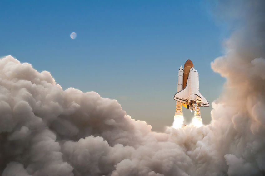 Space Shuttle starts its mission and takes off into the sky. Rocket with clouds of smoke flying into space