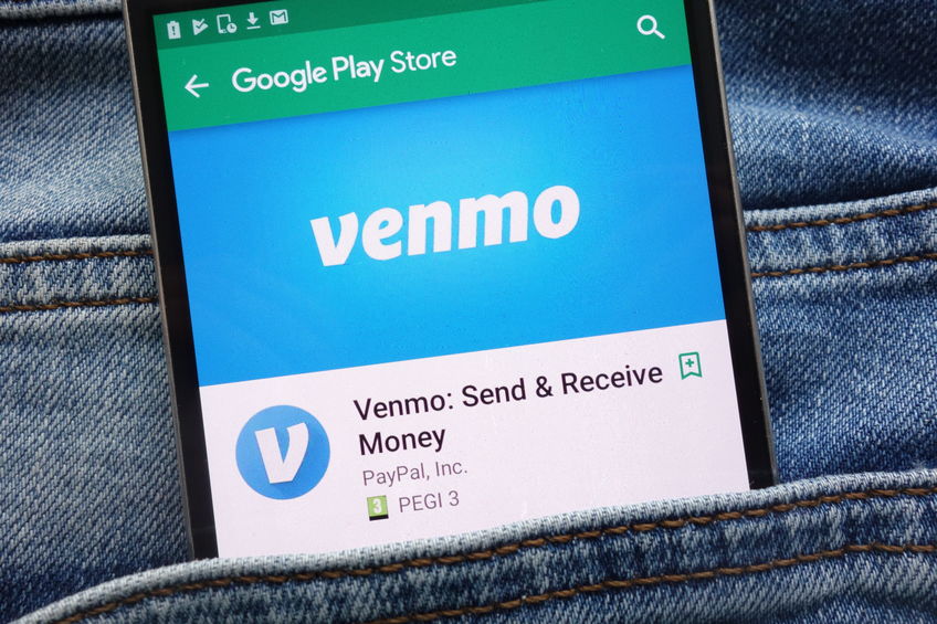 venmo app on google play store website displayed on smartphone hidden in jeans pocket