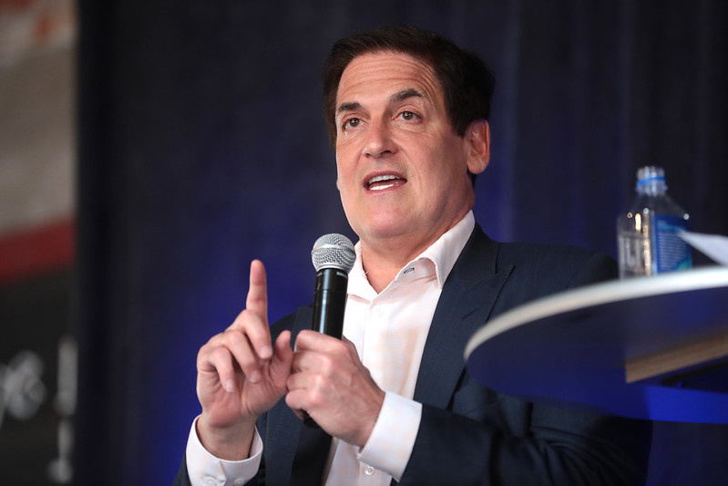 Business man speaking about DeFi in front of a crowd