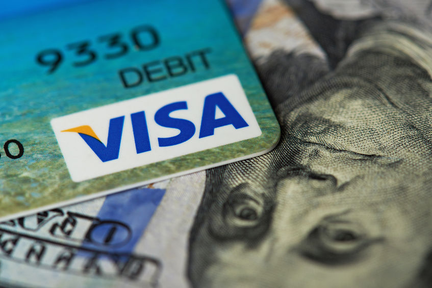 Close-up of visa card on dollar bill background