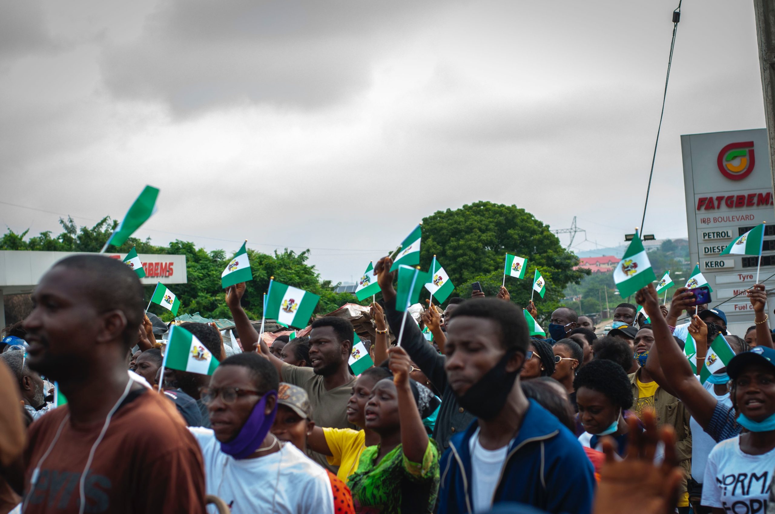 A gathering of Nigerians waving national flags.