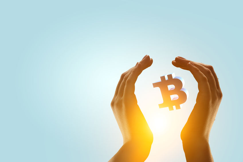 Diamond hands holding Bitcoin.