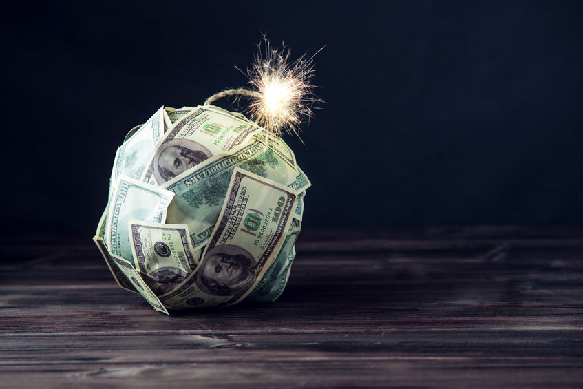 Big bomb of money hundred dollar bills with a burning wick. Little time before the explosion. The concept of financial crisis