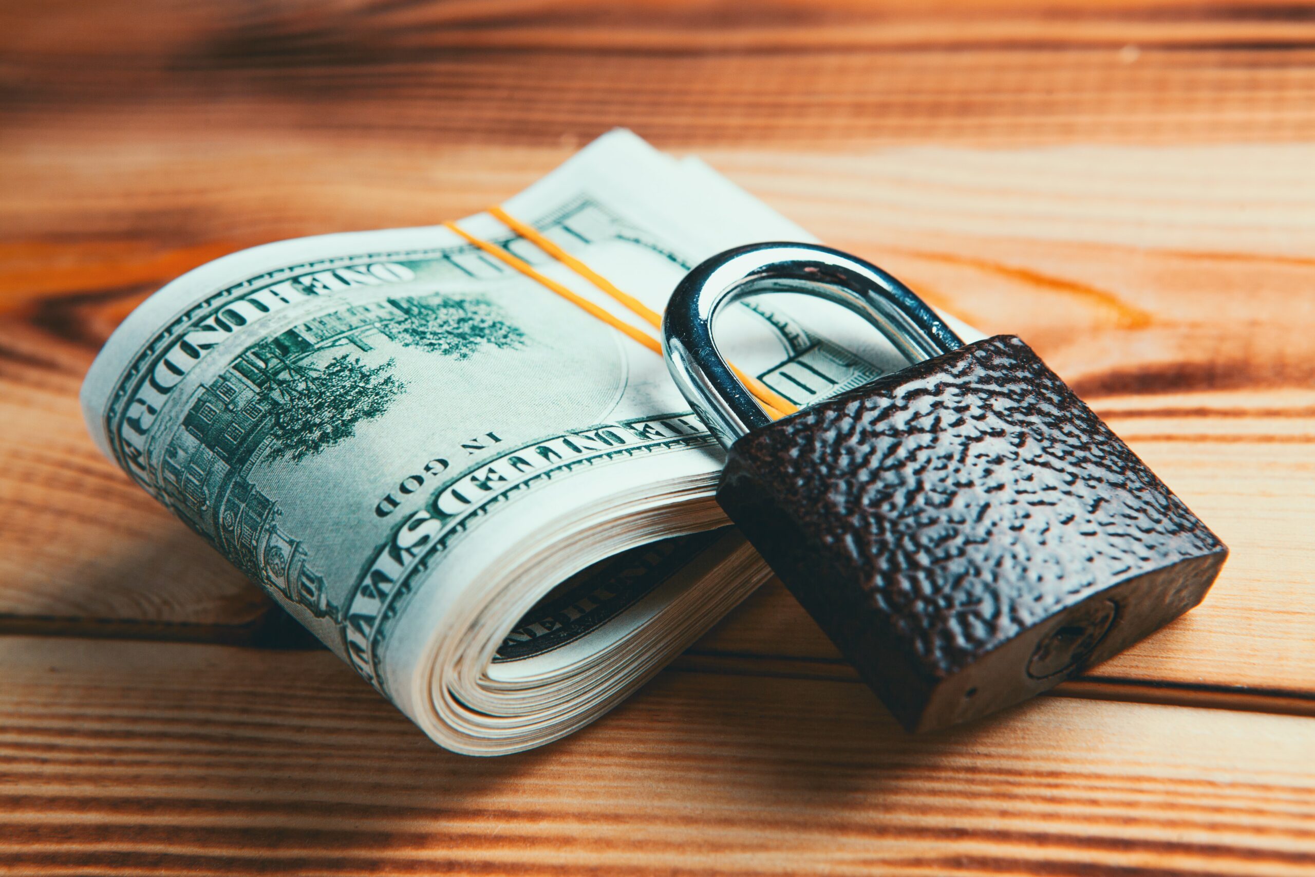 US dollar next to a lock, to show that its status as a store of value may be diminishing, but it could still be used for payments worldwide