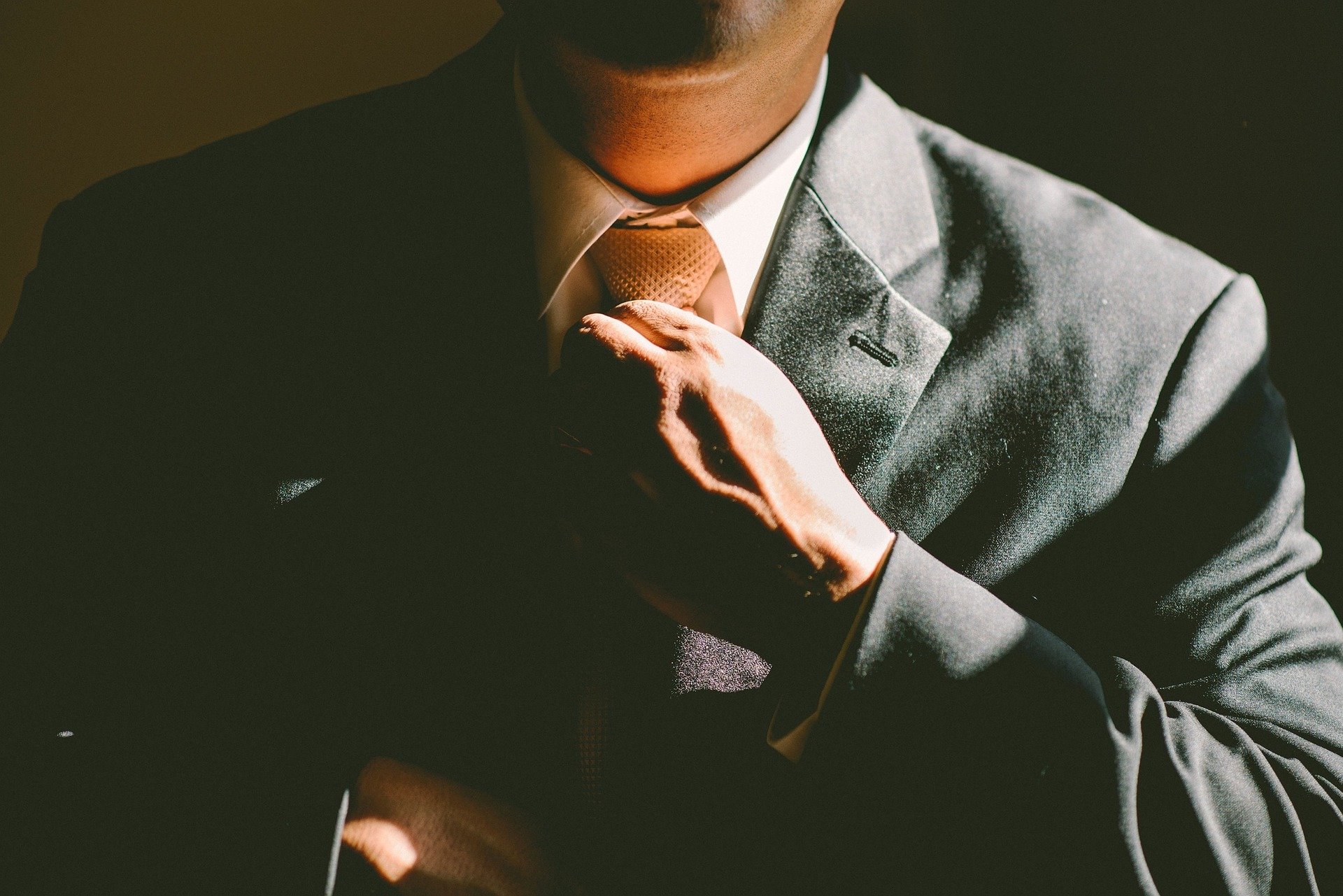 A man tying his tie.