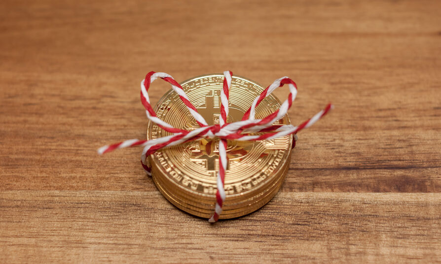 golden bitcoin coins wrapped as gift virtual money