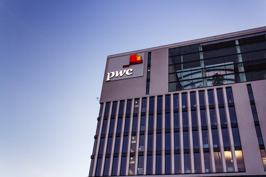PwC tax office building in munich entry logo sign blue sky empty space
