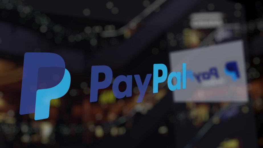 PayPal logo on the glass against blurred business center.