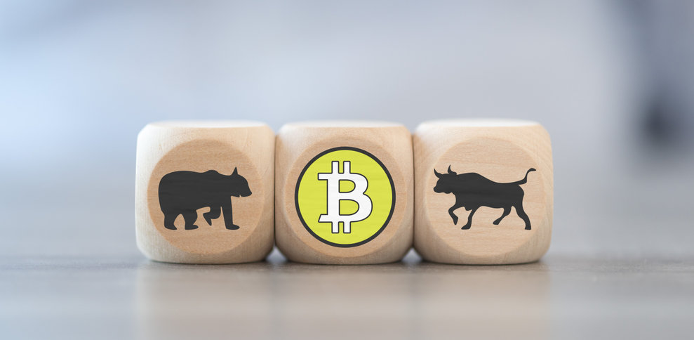 Bitcoin symbol surrounded by symbols for bullish and bearish market