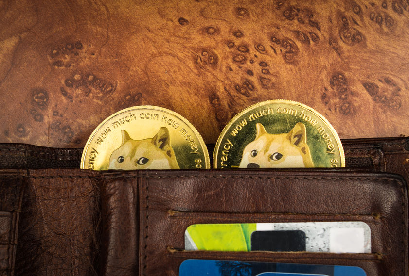 Dogecoins in a wallet on a table