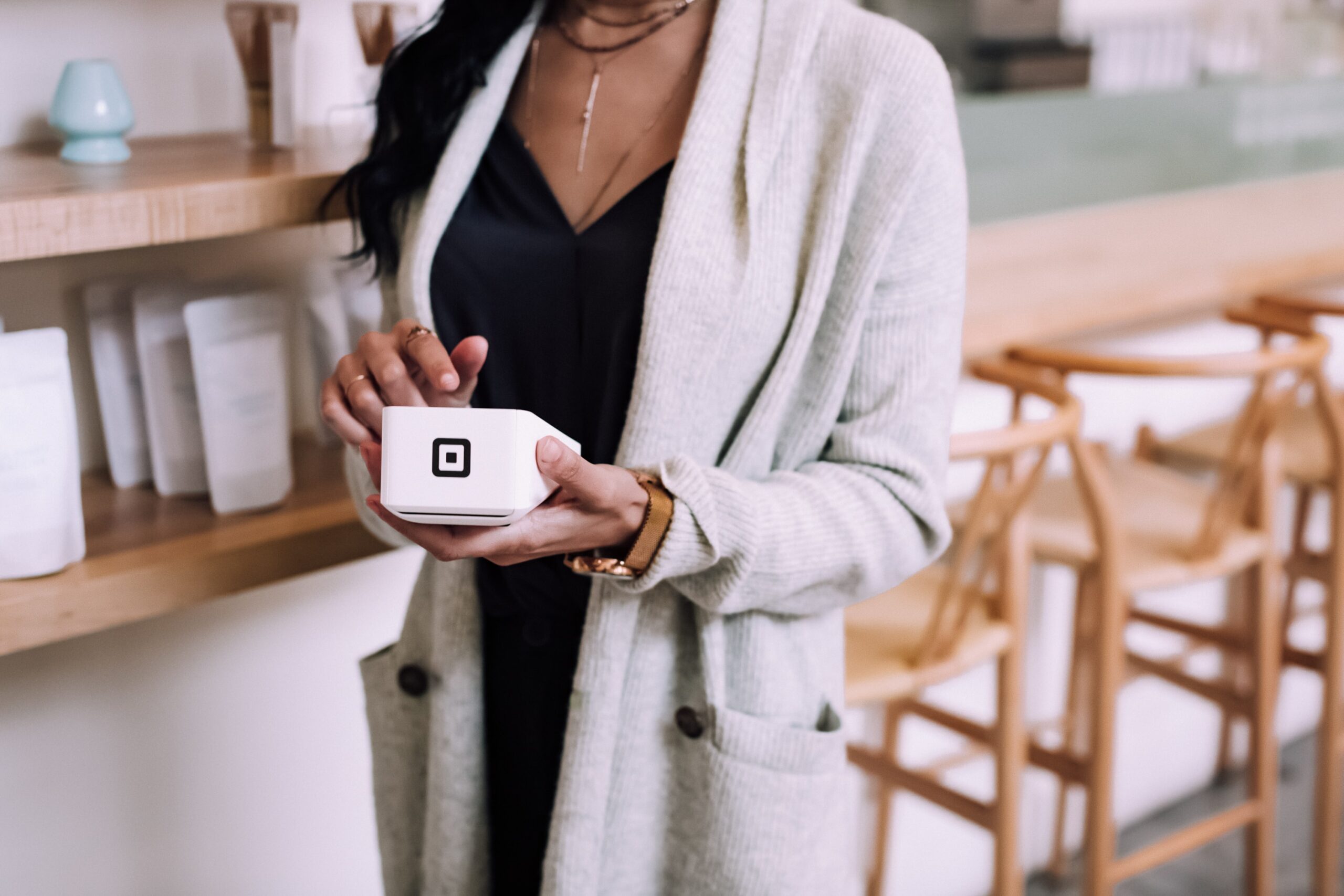 Person using Square's hardware payment tool, signifying Square's ability to make physical payment solutions