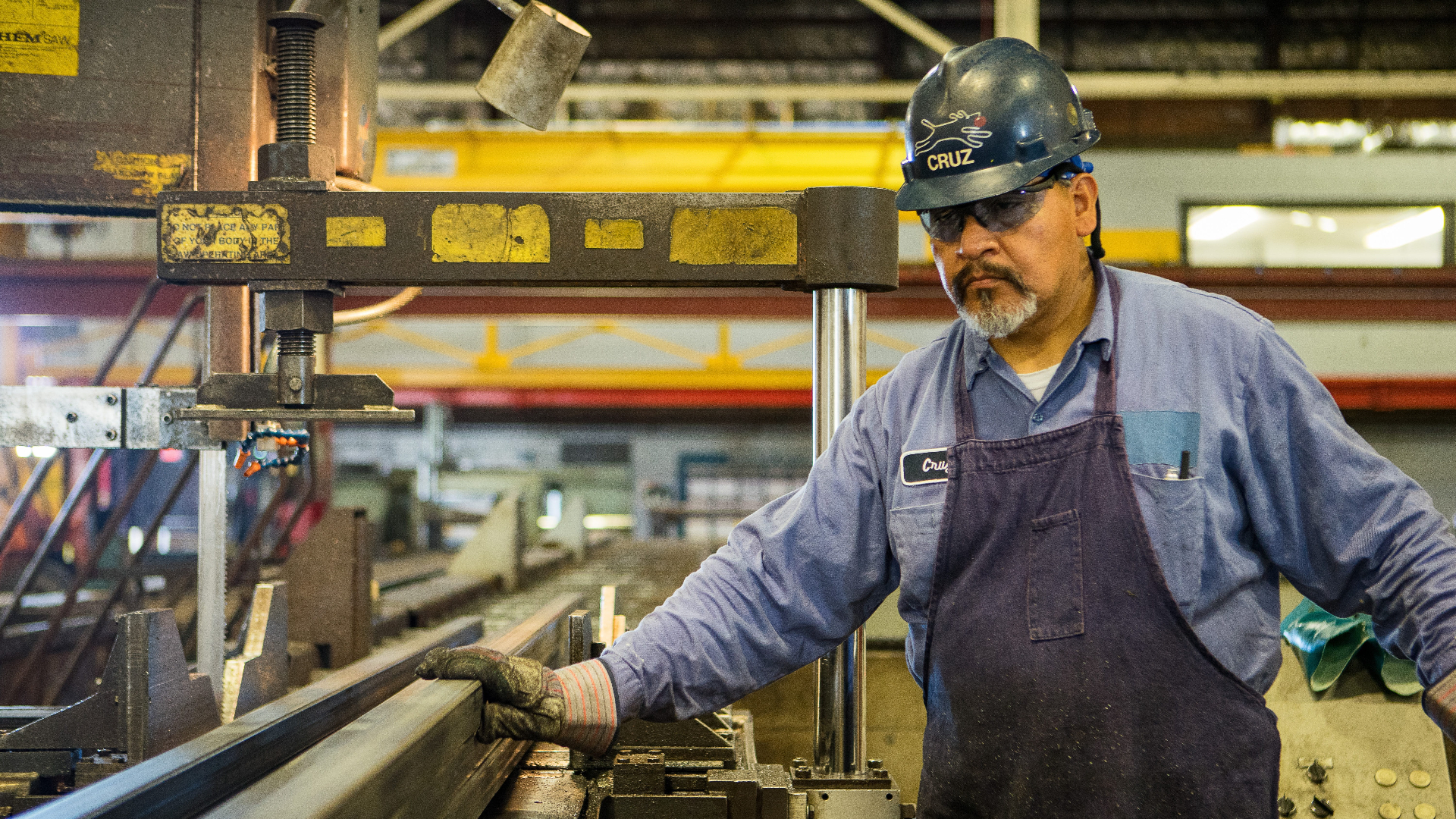 Factory worker operating machinery.