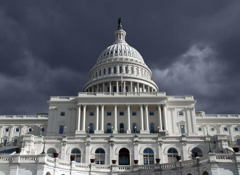 US Capitol building with dark storm sky in Washington DC.