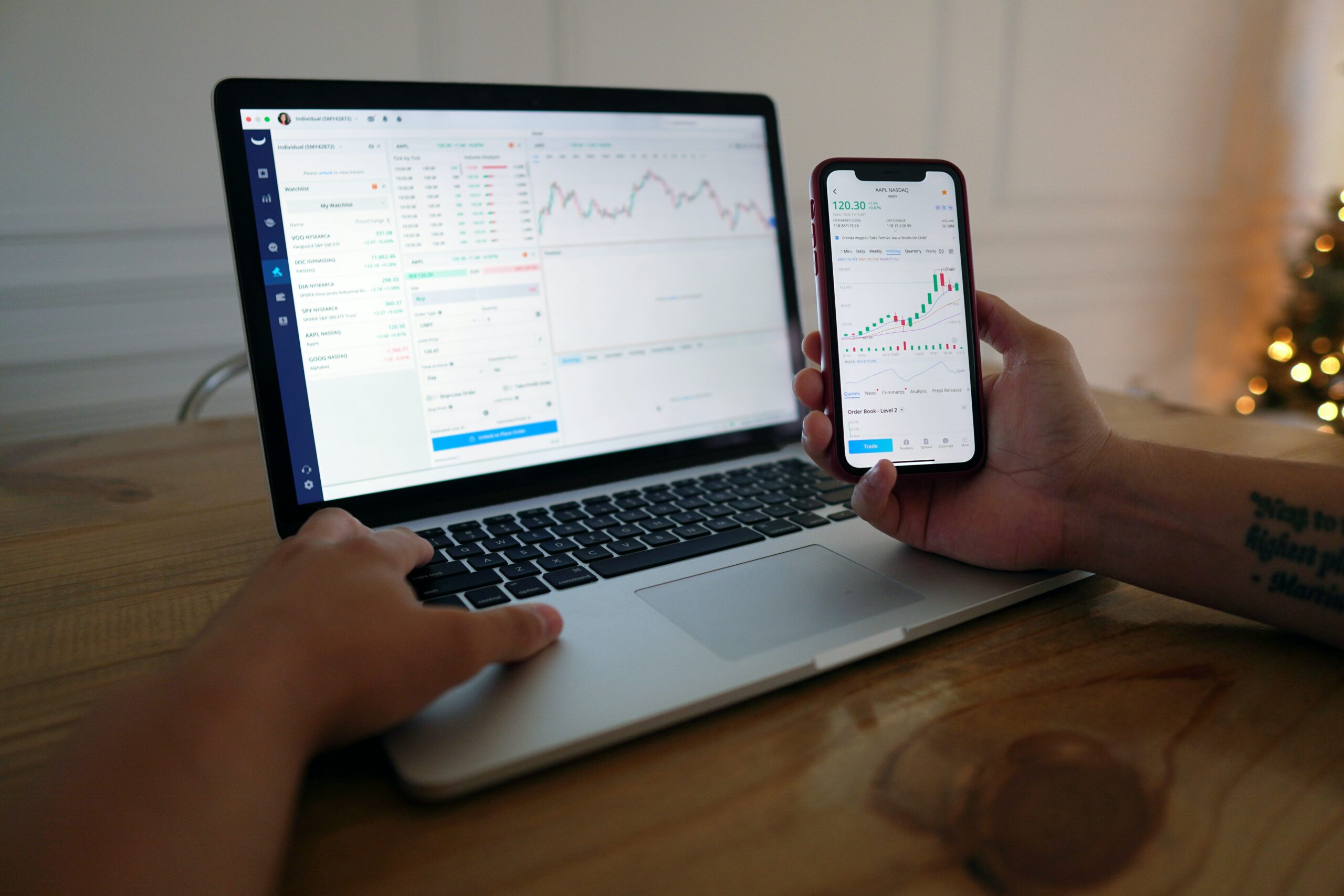 Trader showing his traders on laptop and mobile phone.