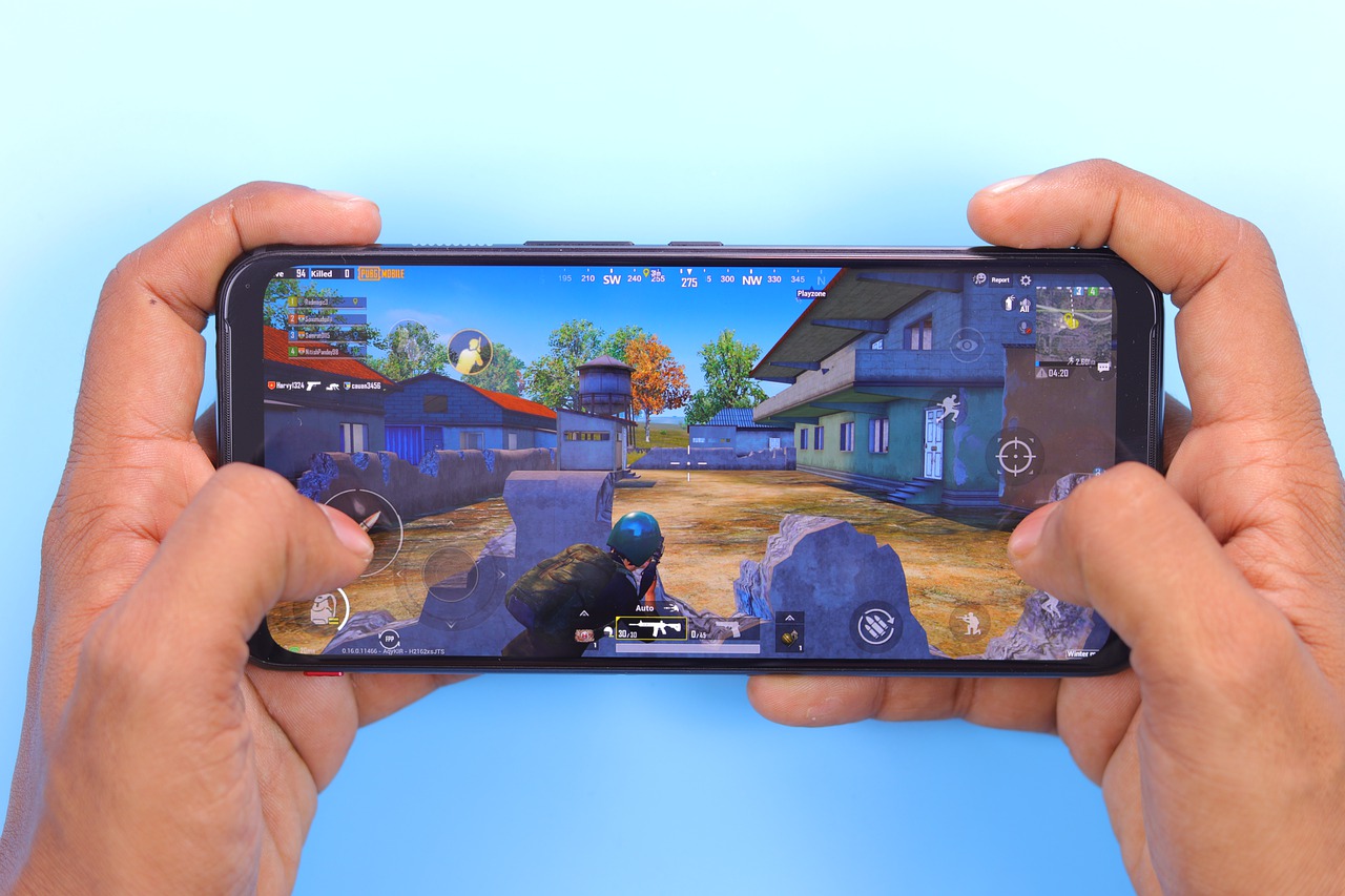 A man playing video game with mobile device.