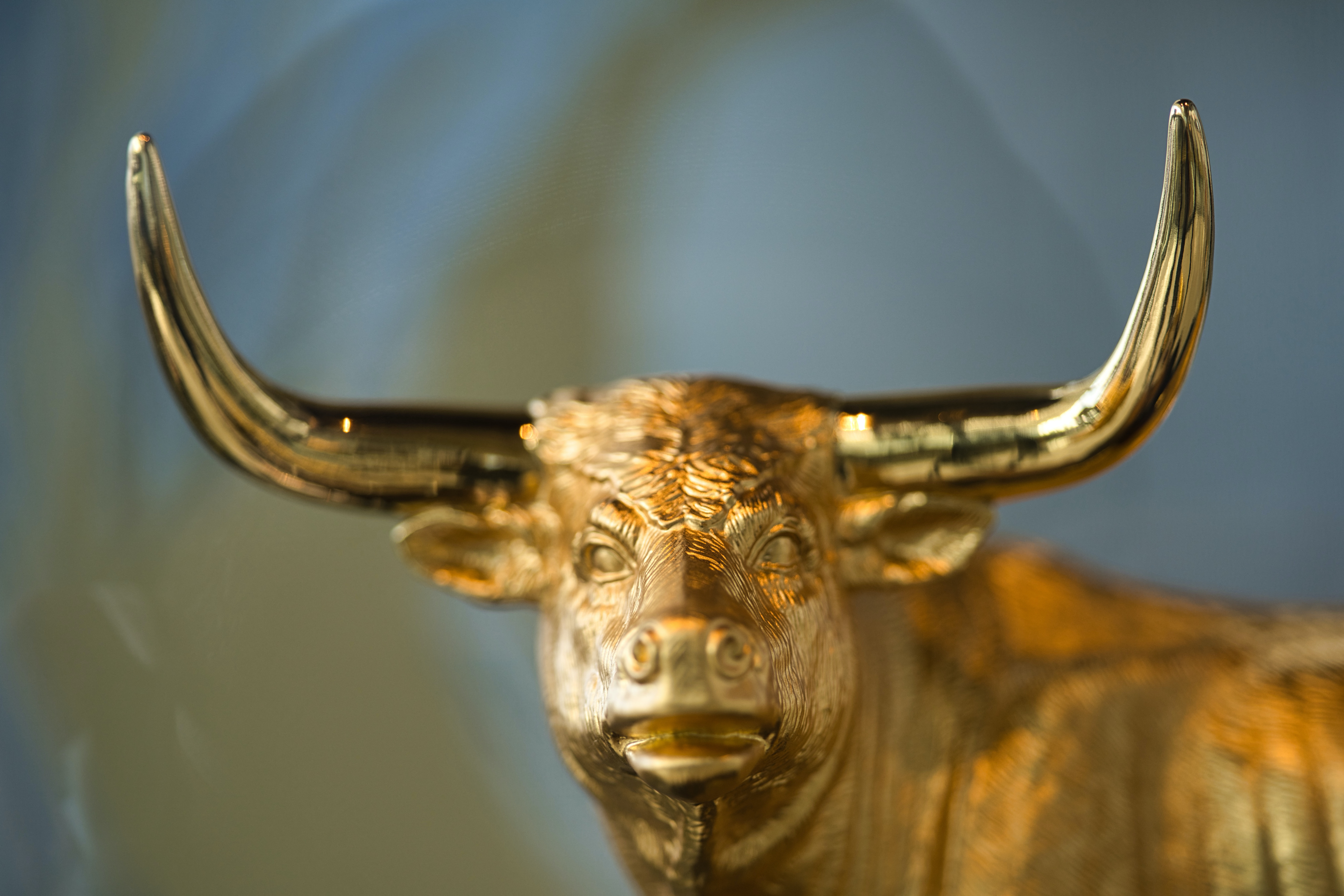 Statue of a golden bull with long horns.
