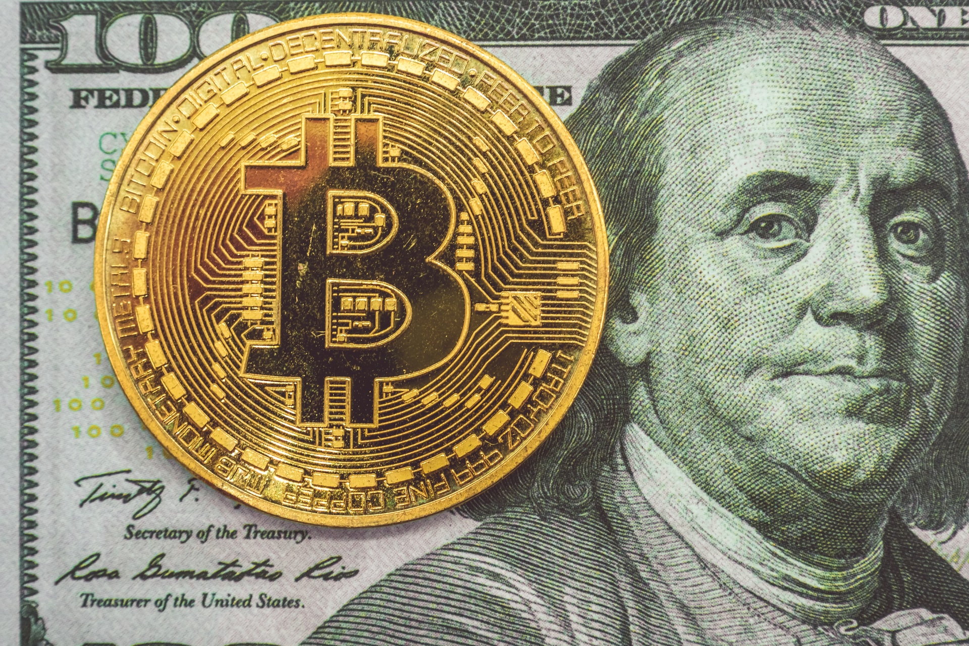 Bitcoin and $100 USD note