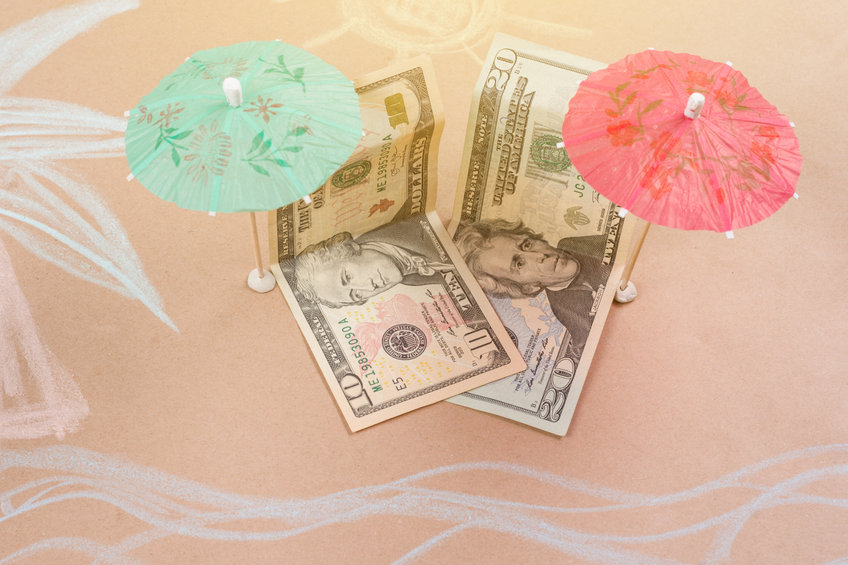 An image of US dollars on a beach with cocktail stands to represent a tax havan