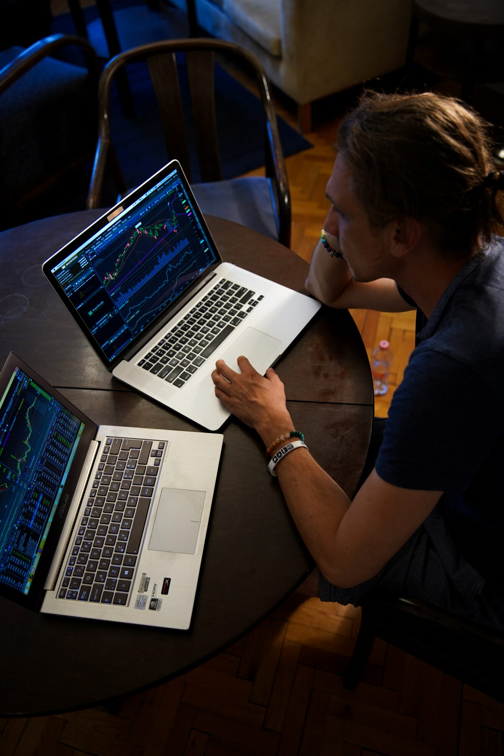 Image of trader looking at several screens