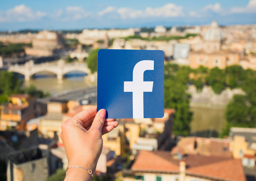 Image of Facebook logo with Rome in the background